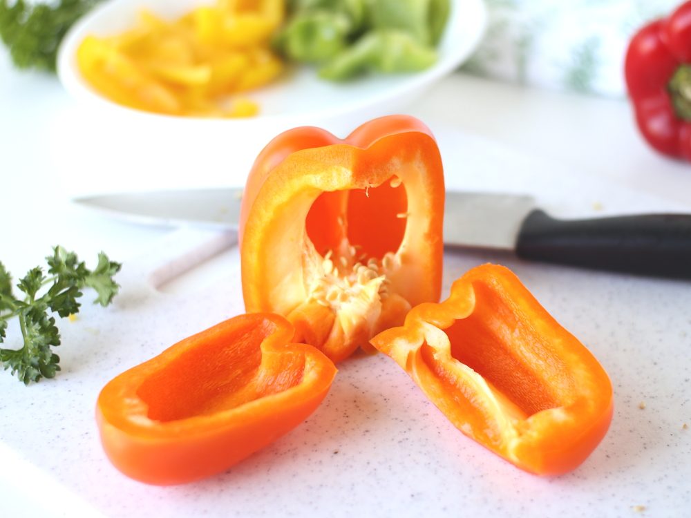 sliced orange bell pepper on white cutting board