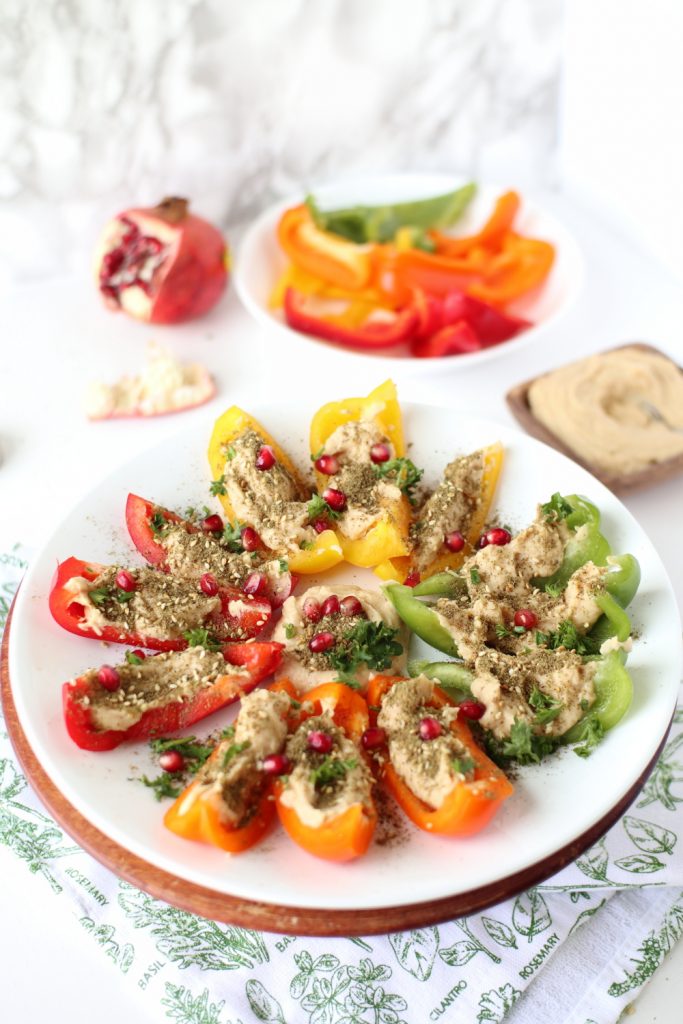 bell peppers zaatar spiced hummus on plate presentation white background