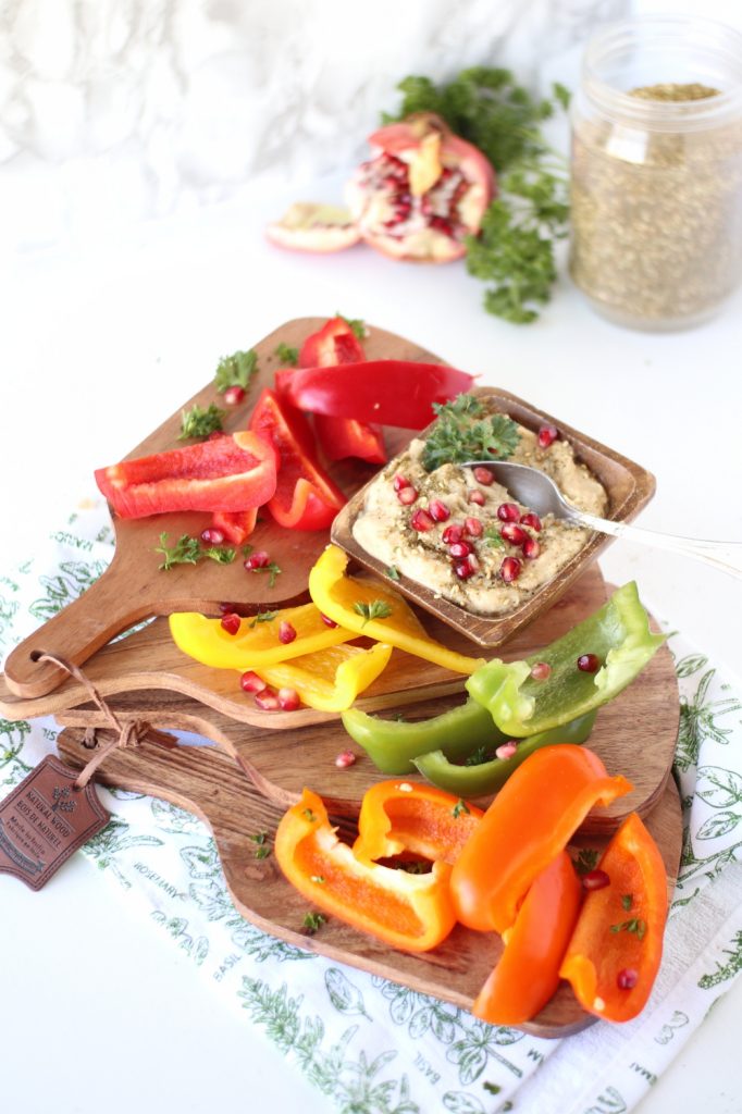 bell peppers zaatar spiced hummus ingredients on wooden charcuterie boards