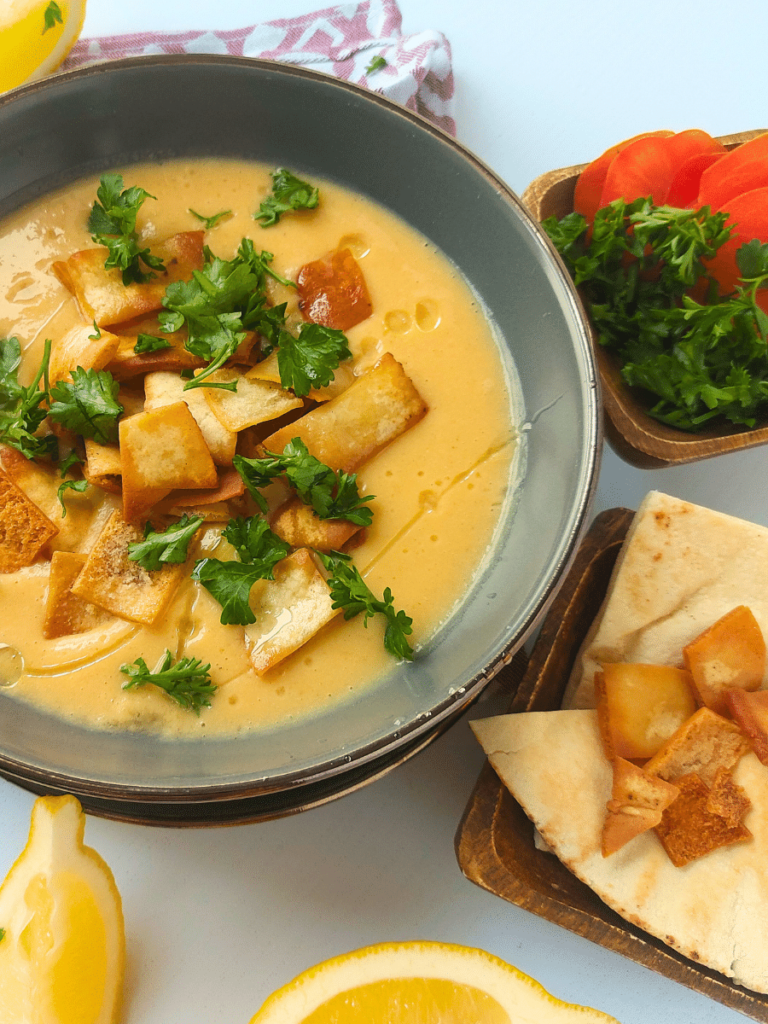 lebanese lentil soup recipe shorbat adas close up texture pita bread tomato parsley pita chips lemon