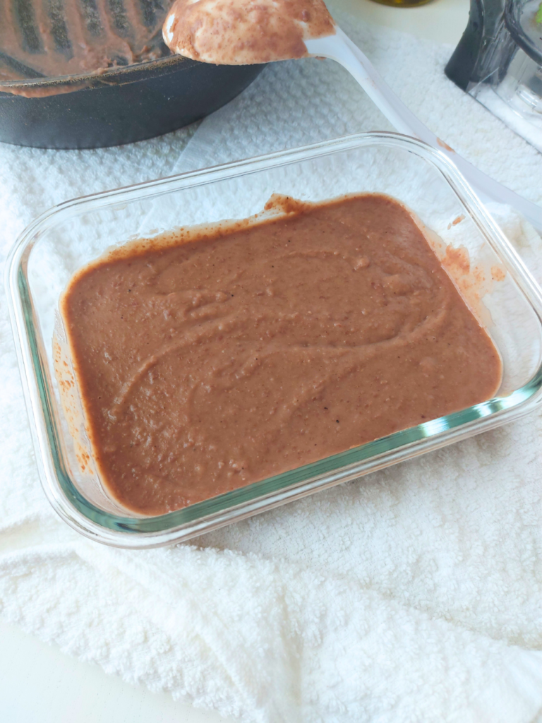 close up of refried beans in glass container