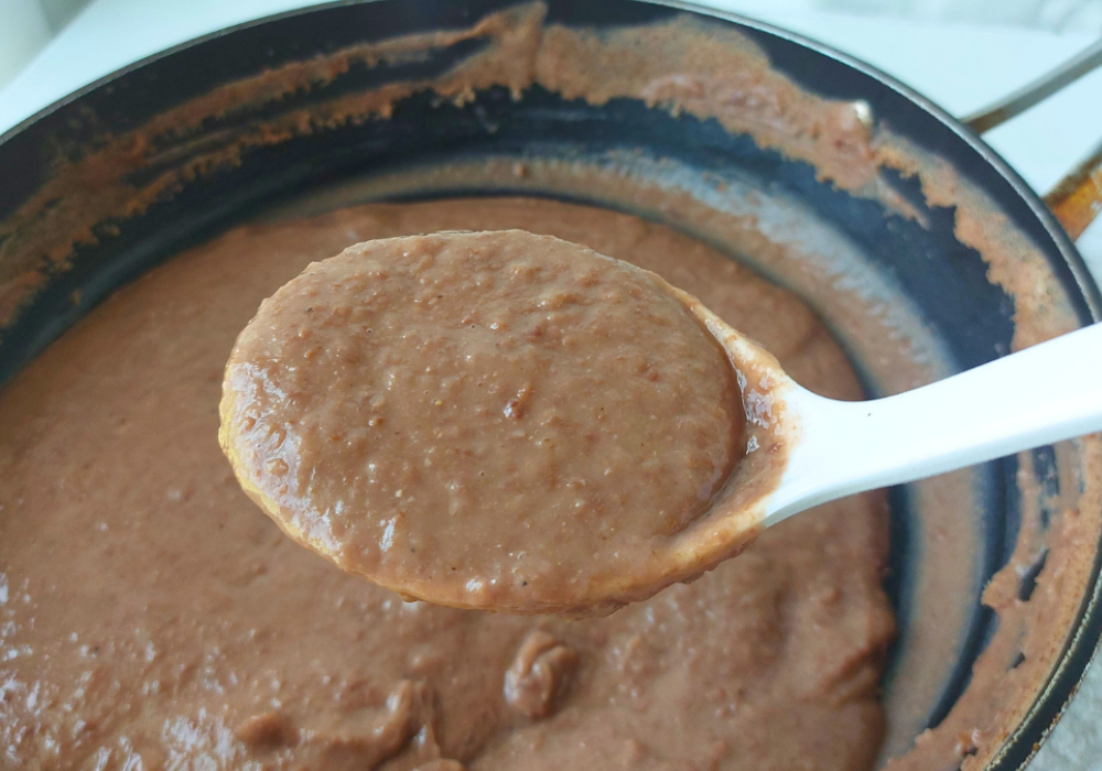 spoonful of honduran frijoles over pan